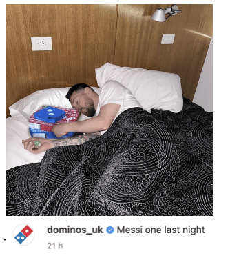 Image of a Dominos Pizza social image showing Lionel Messi with a pizza box in his bed, captioned "Messi one last night"