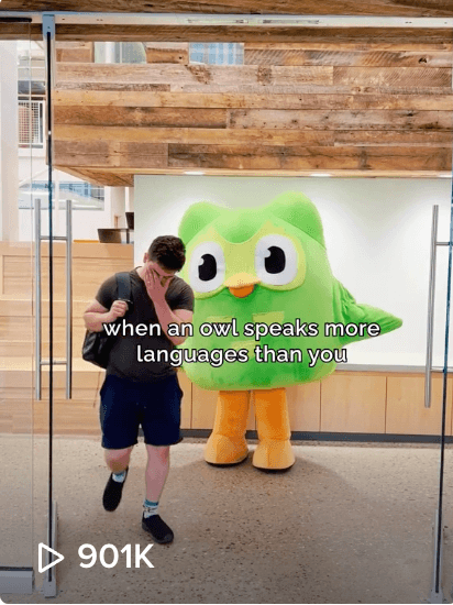 Social image of a man covering his face in shame as he passes the Duolingo owl with the caption "when an owl speaks more languages than you"