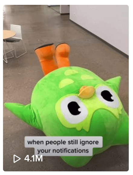 Social image of a distressed Duolingo owl lying on the ground with a caption "when people still ignore your notifications"