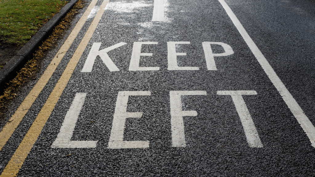 Road marking reading "KEEP LEFT"